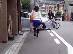 Asian whore pees behind car