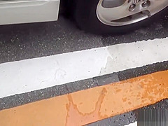 Asian whore pees behind car