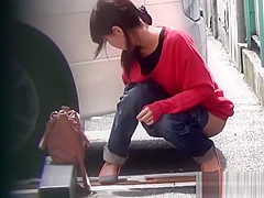 Asian whore pees behind car