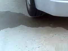 Asian whore pees behind car