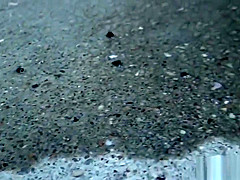 Asian whore pees behind car