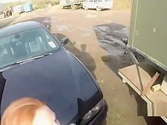 Busty redhead fucks on police car