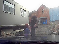 Busty redhead fucks on police car