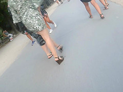 Candid young blond, sexy legs in wedges heels