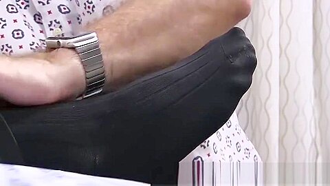 Hunky dude receives a skillful foot massage from his friend