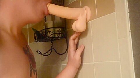Shaved twink practices deepthroating in the shower