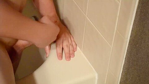 Shaved twink practices deepthroating in the shower