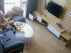 Young couple in livingroom, riding on sofa