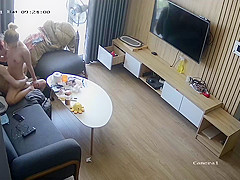 Young couple in livingroom, riding on sofa