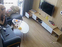 Young couple in livingroom, riding on sofa