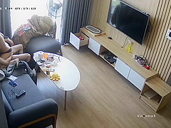 Young couple in livingroom, riding on sofa