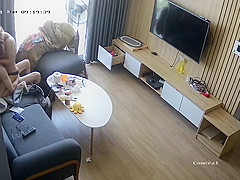 Young couple in livingroom, riding on sofa