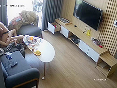 Young couple in livingroom, riding on sofa