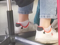 candid feet in white ankle socks and sneakers